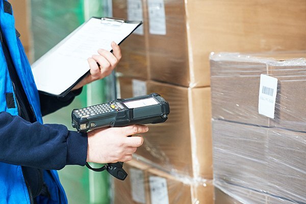 Logistics employee scanning boxes