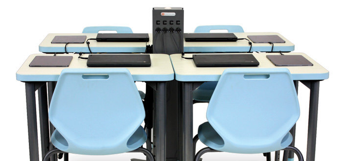 A Bretford CUBE Tower Pre-Wired USB-C charging tower between a group of desks