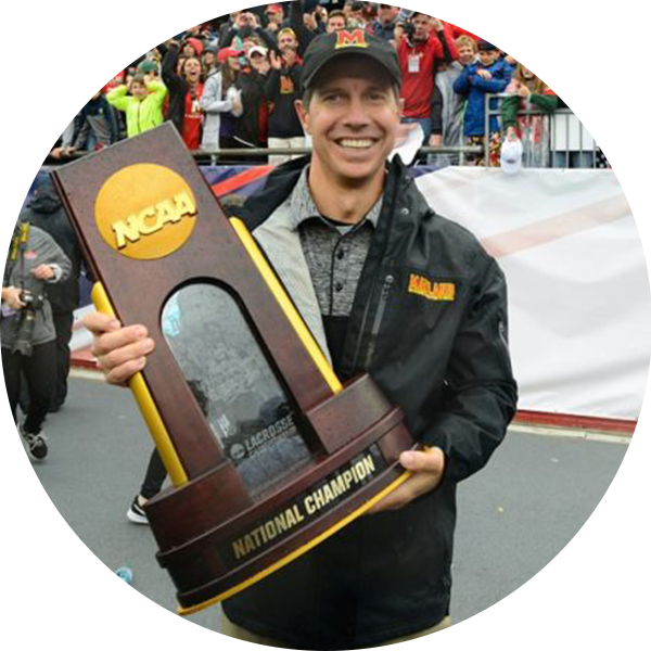 John Tillman, Head Coach of the University of Maryland, holding an NCAA "National Champion" trophy
