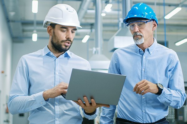 manufacturing warehouse employees with computer